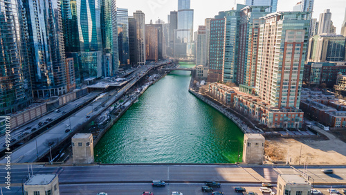 Chicago, IL USA- march 13th 2022: aerial drone shot of downtown Chicago by the river during early spring summer.  the beautiful skyscrapers look futuristic  along the green lake water