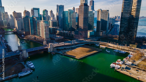 Chicago, IL USA- march 13th 2022: aerial drone shot of downtown Chicago by the river during early spring summer.  the beautiful skyscrapers look futuristic  along the green lake water