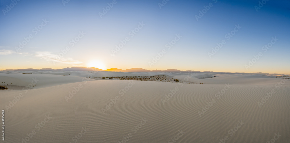 Panorama Of Sun Setting Over The Vast Emptiness of White Sand Dunes