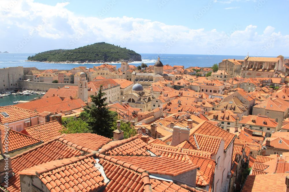 Beautiful Dubrovnik Croatia landscapes welcome visitors and tourists in Mediterranean warmth and vivid colors by the ocean with blue waters and red roofs