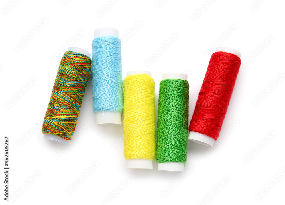 Different thread spools on white background Different thread spools on white background