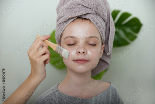 Wallpaper Mural Little girl enjoys facial  cream mask on their faces. Little girl and young woman enjoy spa procedures. Home SPA and wellness Torontodigital.ca