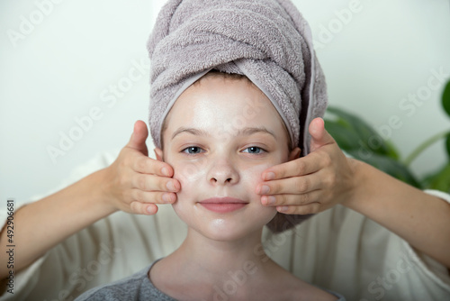 Wallpaper Mural Little girl enjoys facial massage cream mask on their faces. Torontodigital.ca