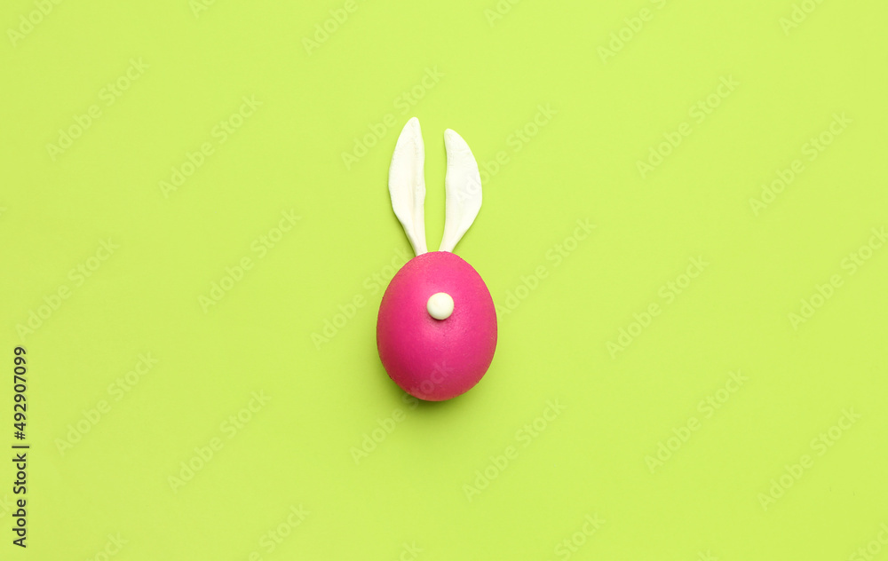 Rabbit made of painted Easter egg and bunny ears on green background Rabbit made of painted Easter egg and bunny ears on green background