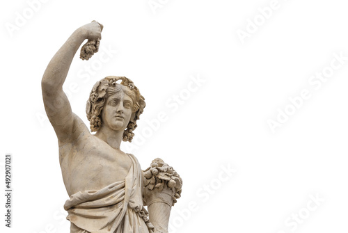 Paganism in Ancient Times. Roman or Greek god Bacchus holding grapes, a neoclassical marble statue, erected in the 19th century in Rome historic center (Isolated on white background with copy space) photo