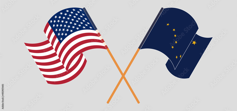 Crossed and waving flags of the USA and the State of Alaska Crossed and waving flags of the USA and the State of Alaska