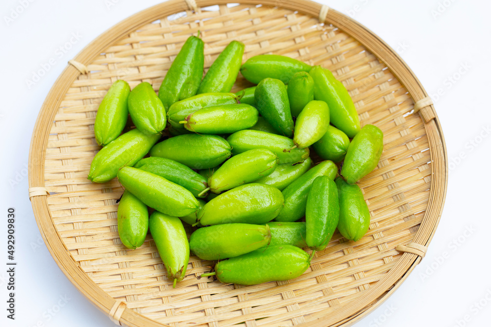 Bilimbi fruit in bamboo basket on white background. Bilimbi fruit in bamboo basket on white background.