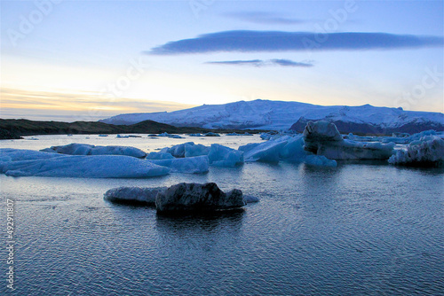 Beautiful Iceland scenes from the Glacial Lagoon during golden hour as large pieces of glacier float through the lagoon and make their way out to sea