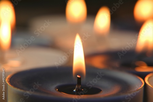  Candle flame.White and blue burning candles .Candles background. Zen and relaxation concept.Magic and esoteric.