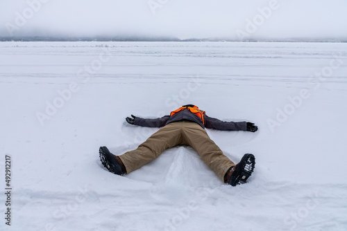 Snow angel on Gunflint Lake in Northern Minnesota on the Canadian Border edge of the Boundary Water Canoe Area Wilderness frozen lake photo