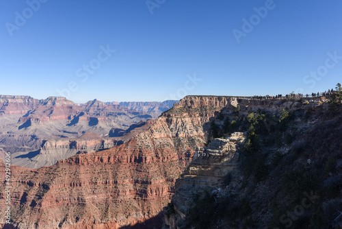 People standing on the rim of the Grand Canyon.