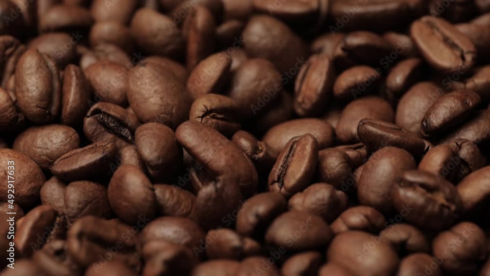 Coffee beans. Camera slowly pans up to show roasted coffee beans. Close-up Coffee beans. Camera slowly pans up to show roasted coffee beans. Close-up