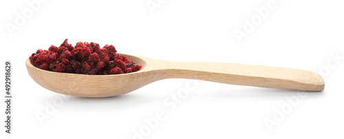 Dried red currants in wooden spoon on white background