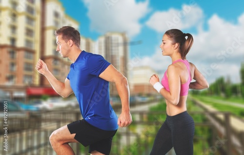 People sport running concept. Happy runner couple exercising outside as part of healthy lifestyle.