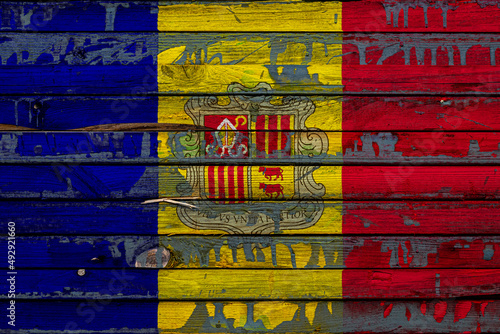 The national flag of Andorra is painted on uneven boards. Country symbol.