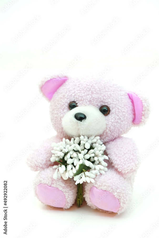 Toy bear with a bouquet.  Preparation for a romantic holiday at home, soft morning light. Valentines Day, Birthday  and love Concept