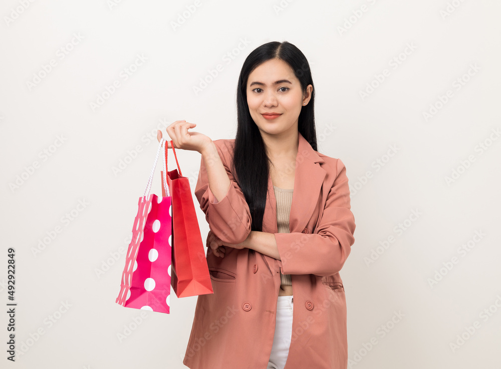 Portrait beautiful asian women in fashion style standing pose holding a lot of shopping bag on isolated white background. Attractive Happy business woman in pink suit going to shopping Portrait beautiful asian women in fashion style standing pose holding a lot of shopping bag on isolated white background. Attractive Happy business woman in pink suit going to shopping