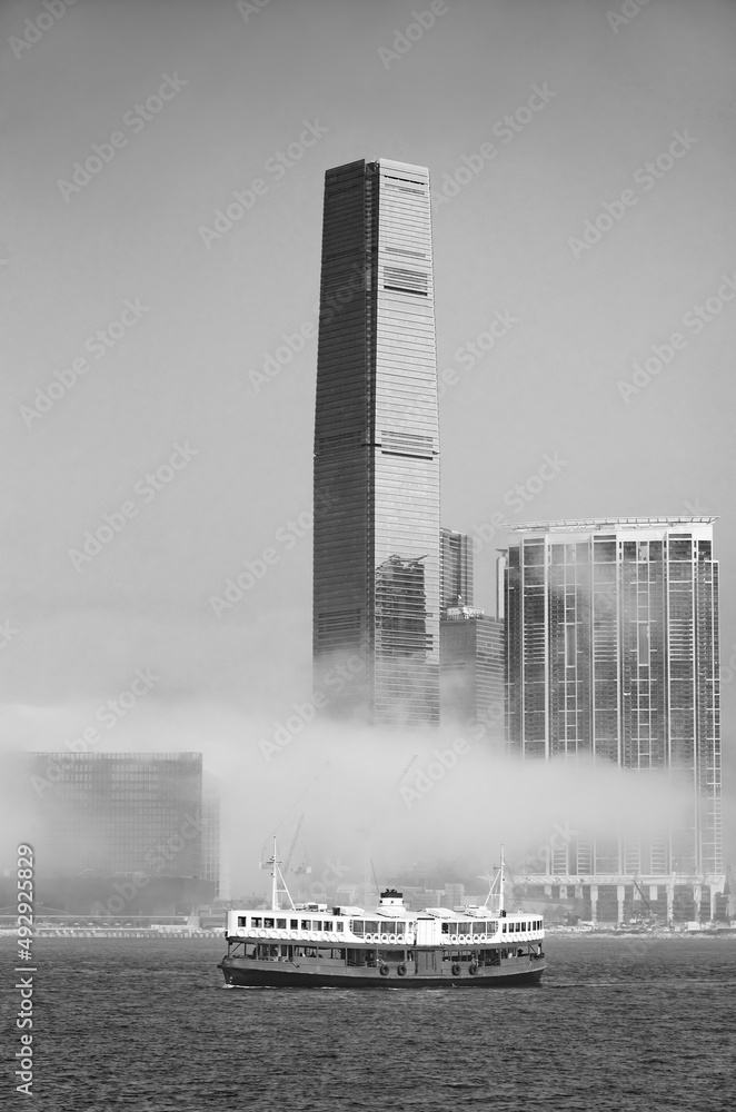 Skyscraper and ferry in Victoria harbor of Hong Kong city