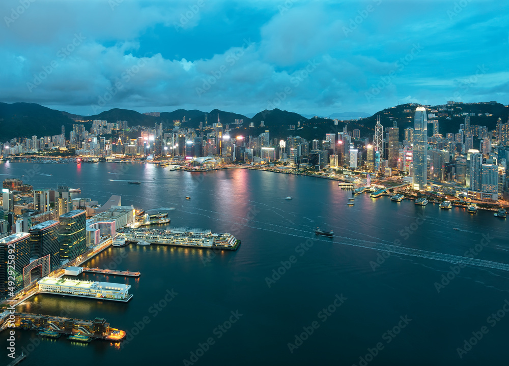 Aerial view of Victoria Harbor of Hong Kong city at dusk