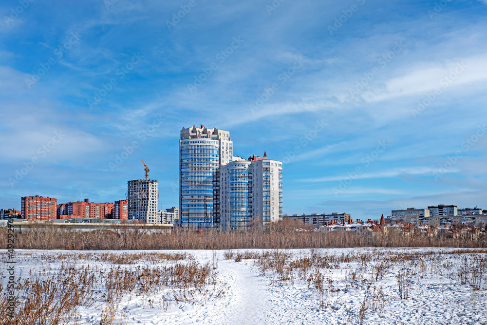 A new residential area is being built on the outskirts of the city on a sunny winter day A new residential area is being built on the outskirts of the city on a sunny winter day
