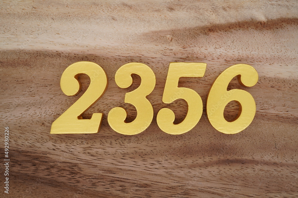 Golden Arabic numerals on a real brown and white wooden floor number ...