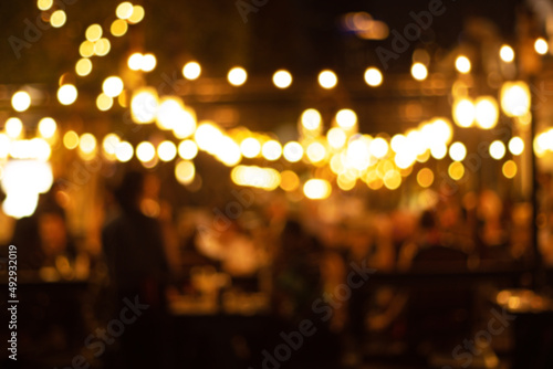 blurred image at the restaurant night time, many people in the restaurant eat and party happy relaxing