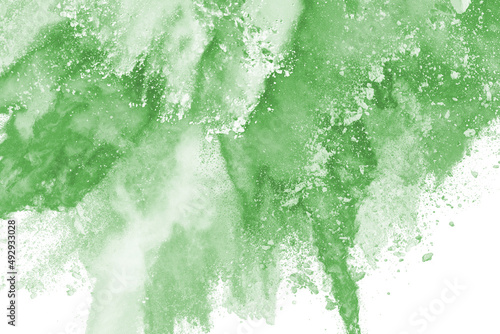 abstract powder splatted background,Freeze motion of green powder exploding,throwing orange dust on white background.