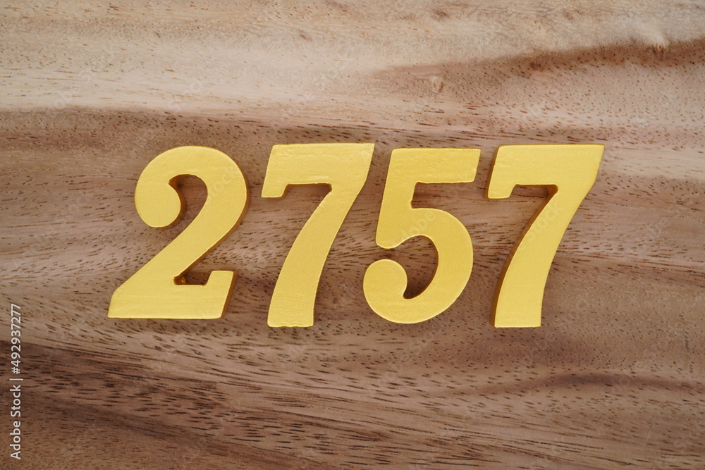 Golden Arabic numerals on a real brown and white wooden floor number ...