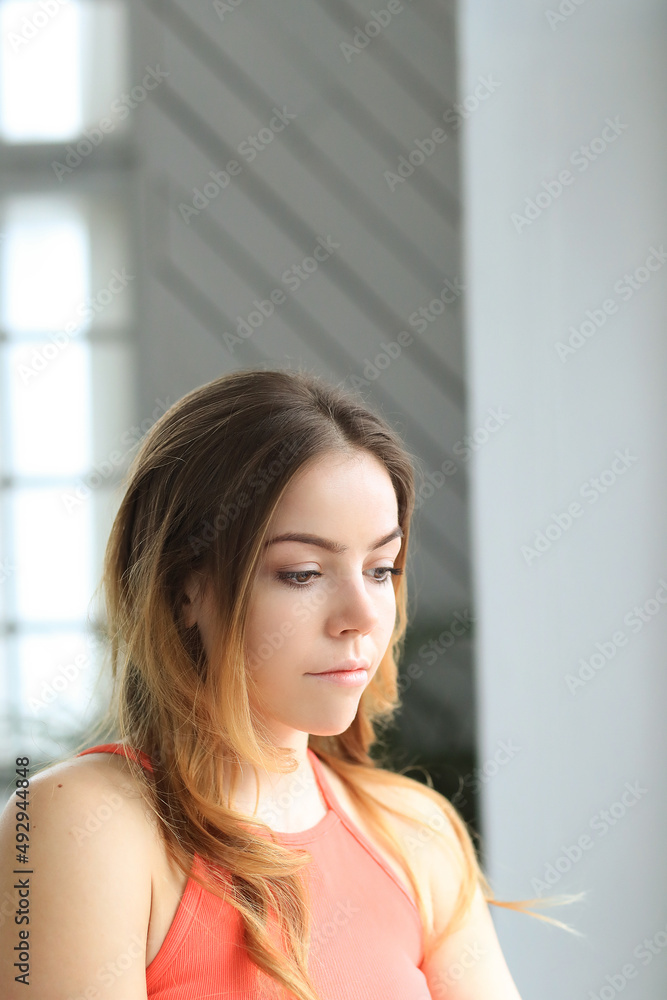Pretty smiling young woman sitting on chair at home Pretty smiling young woman sitting on chair at home