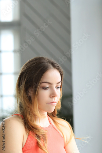 Pretty smiling young woman sitting on chair at home