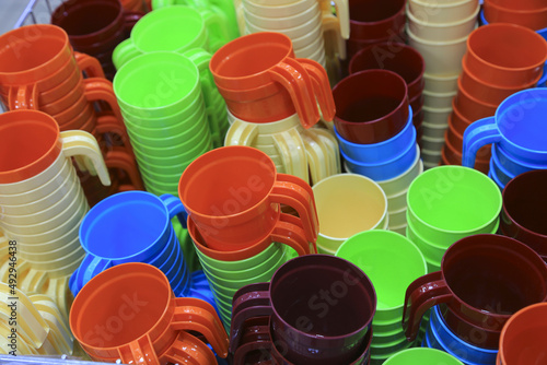 Basket with multi-colored plastic cups. Sale in the store