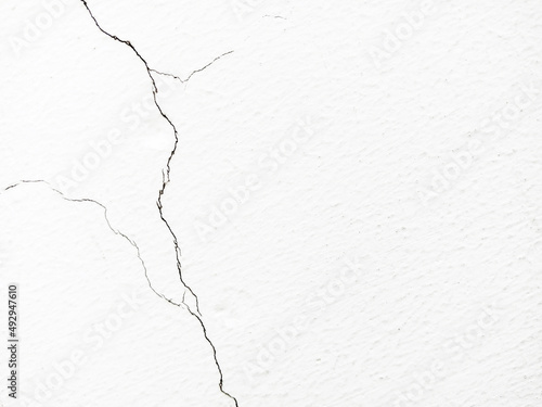 Cracked white wall, concrete wall texture, crack background.
