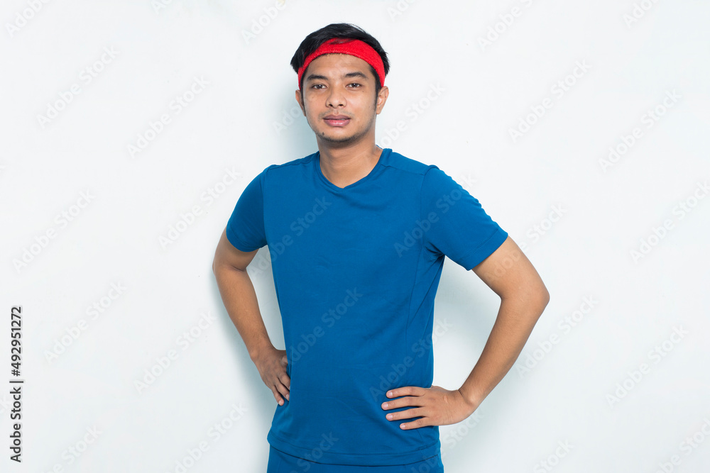 Fototapeta premium portrait young sporty man dressed in blue tshirt on white background 