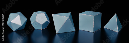 set of five Platonic solids - tetrahedron, cube, octahedron, dodecahedron and icosahedron (blue polyhedra  with worn edges on a black background, banner format) photo