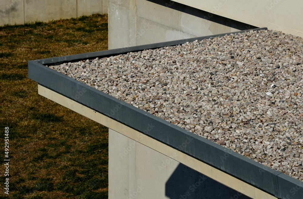 gravel mulch on the roof of a flat green roof. covers and protects layers of insulation and has