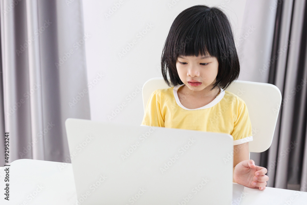 little asian girl student study online using laptop computer at home little asian girl student study online using laptop computer at home