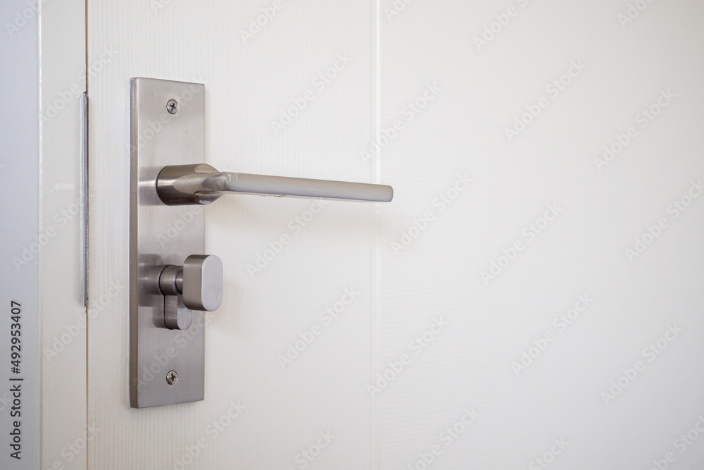 Naklejka premium Modern door handle with on white door