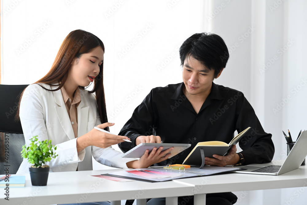 Professional designer discussing on new project and productive strategy with her colleagues. Professional designer discussing on new project and productive strategy with her colleagues.