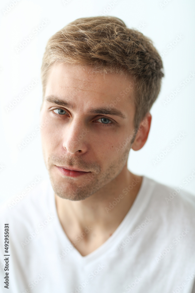 Young man checking his stubble in bathroom Young man checking his stubble in bathroom