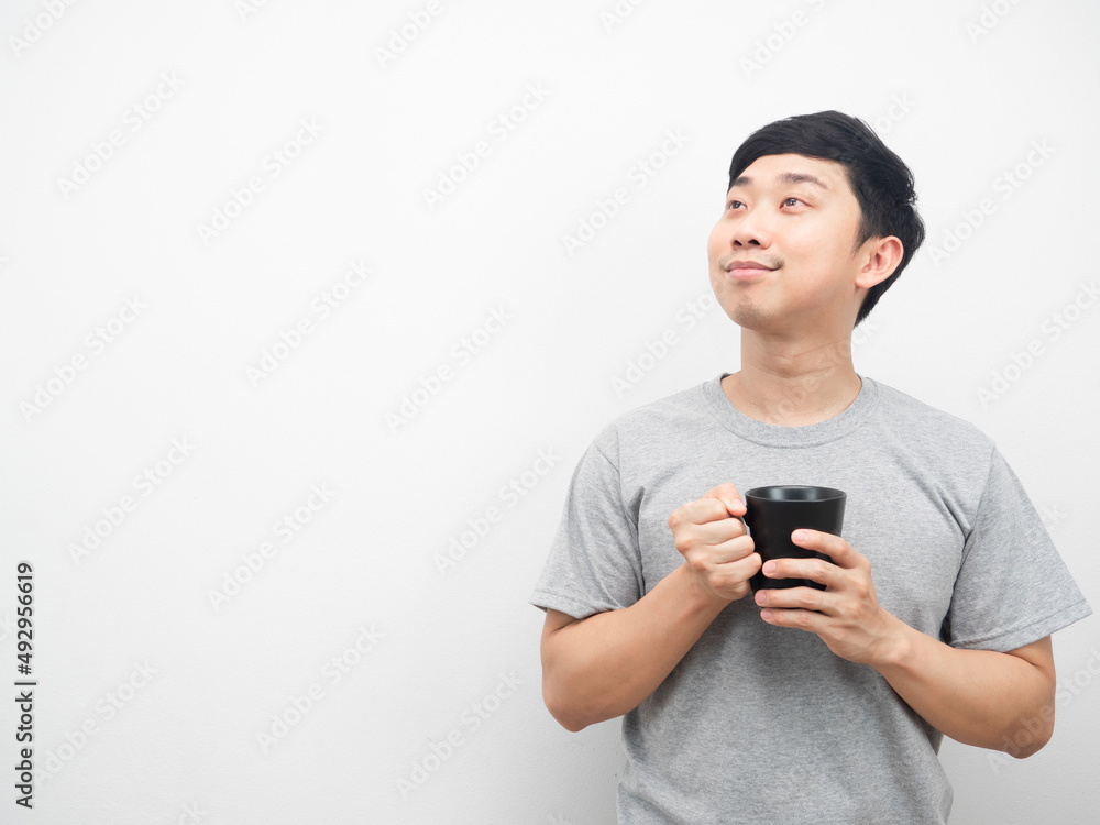 Man holding coffee cup gesture dreaming and looking at copy space Man holding coffee cup gesture dreaming and looking at copy space