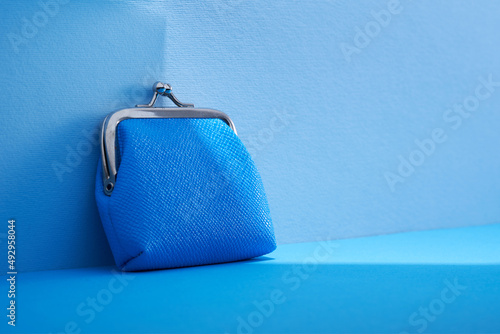 ble coin purse against blue background photo