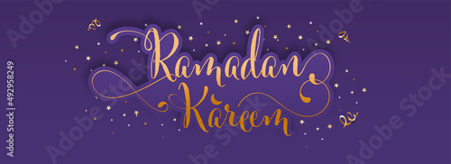 Bronze Ramadan Kareem Font With Confetti And Stars Decorated On Violet Background.