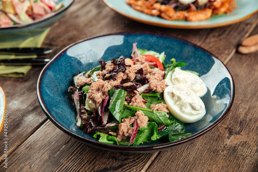 Bowl of healthy tuna and spinach salad with eggs Bowl of healthy tuna and spinach salad with eggs