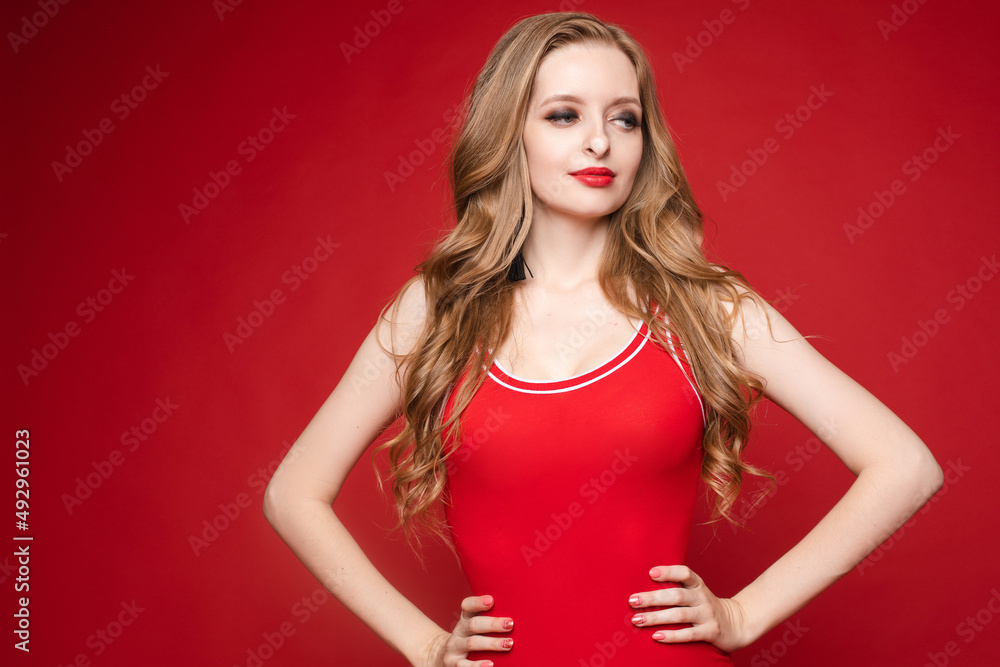 Beautiful female model posing on red background Beautiful female model posing on red background