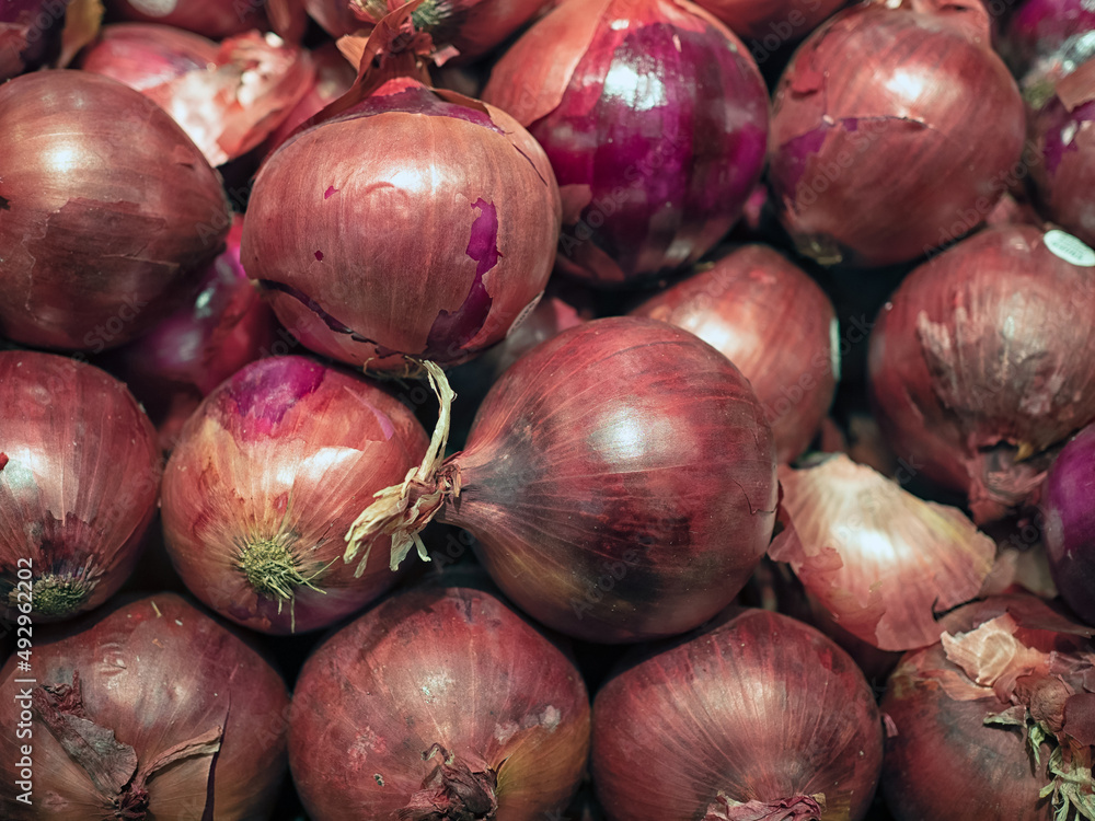 Closeup of fresh raw red Onions at a farmer's market
