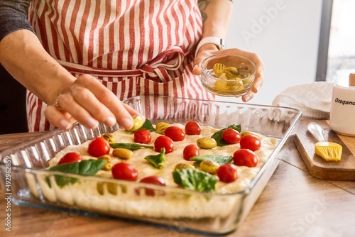 Woman cooking Italian focaccia bread at home. Selected fresh ingredients. Cooking process. Country style. Restaurant  hotel  cafe