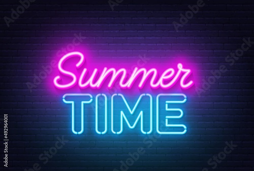 Summer Time neon quote on a brick wall.