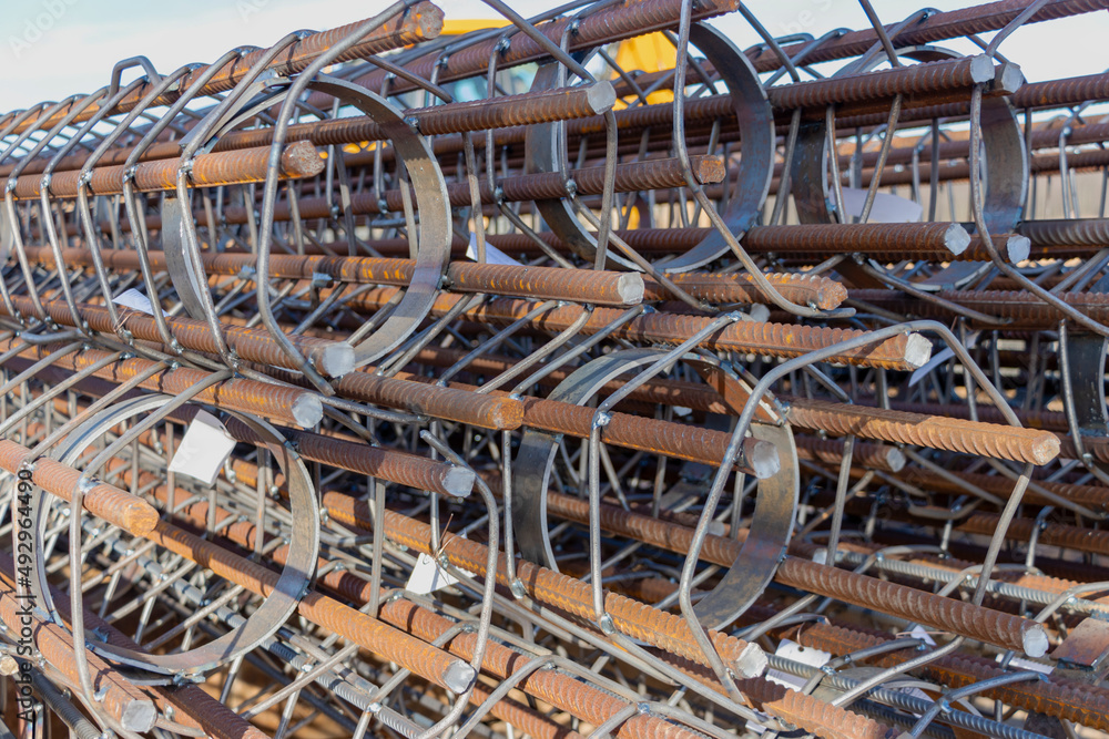 Reinforcing cages for bored piles stacked at the construction site. Reinforcement of reinforced concrete piles. Reinforcing cages for bored piles stacked at the construction site. Reinforcement of reinforced concrete piles.