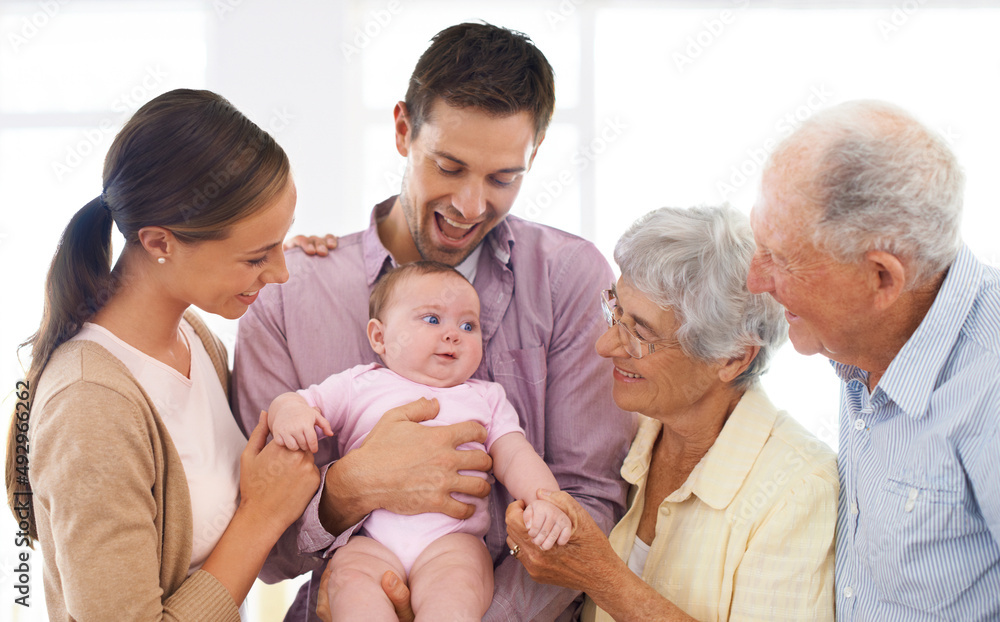 Loving the newest addition to our family. Shot of a three-generational family adoring a baby girl. Loving the newest addition to our family. Shot of a three-generational family adoring a baby girl.