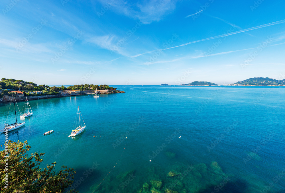 Beautiful seascape and bay in front of the Lerici town, Gulf of La Spezia, Liguria, Italy, southern Europe. On horizon the small town of Porto Venere or Portovenere and the Tino and Palmaria island.